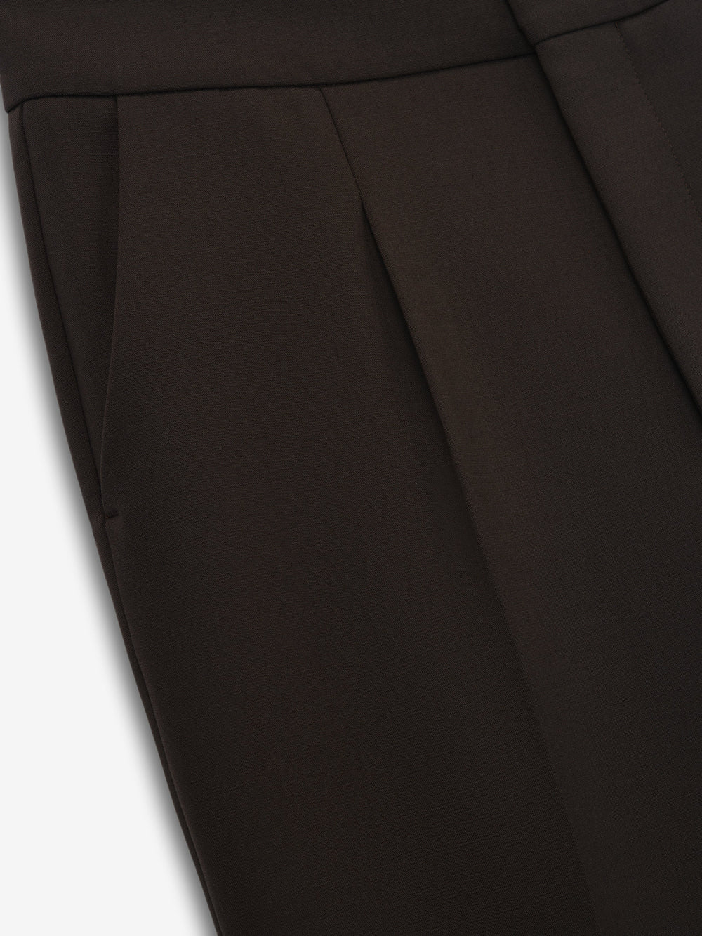 close-up of high-waisted double-weave virgin wool pants with pleats and sleek side pockets in dark brown
