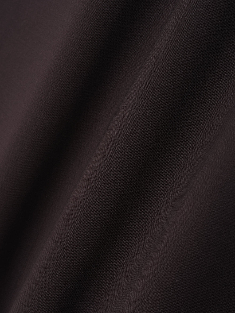 close-up of dark superfine wool canvas fabric with smooth texture and soft drape detail