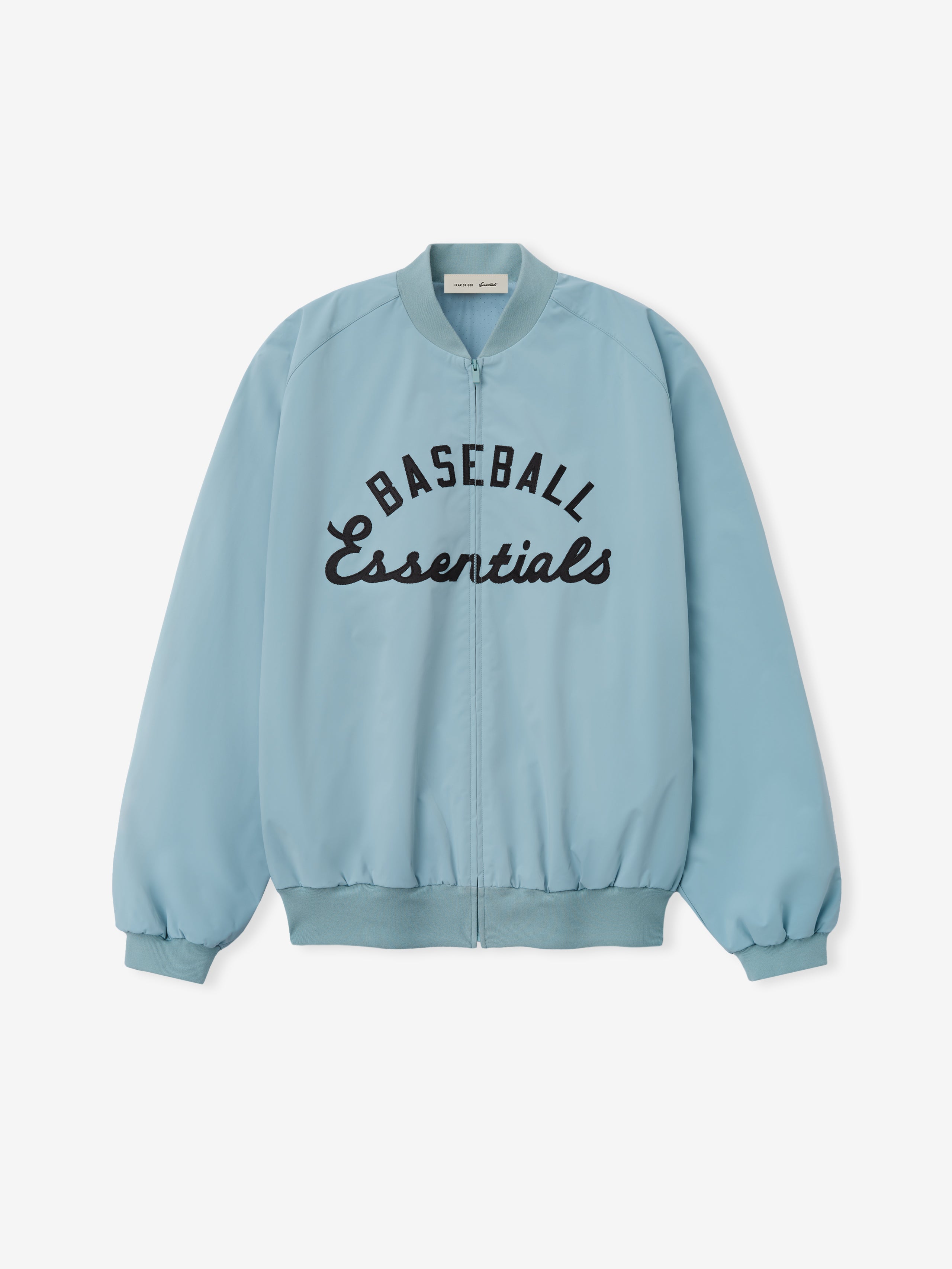 MLB Full Zip Bomber in soft stone blue featuring a full front zipper, ribbed collar, cuffs, and hem, with bold black embroidered "Baseball Essentials" text across the chest, designed as lightweight outerwear.