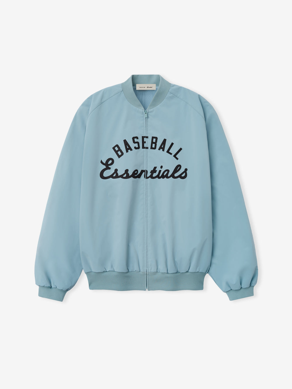 MLB Full Zip Bomber in soft stone blue featuring a full front zipper, ribbed collar, cuffs, and hem, with bold black embroidered "Baseball Essentials" text across the chest, designed as lightweight outerwear.
