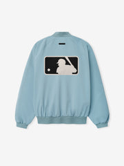 MLB Full Zip Bomber in light blue featuring a ribbed collar, cuffs, and hem, with a large contrasting baseball player silhouette graphic on the back, designed as lightweight outerwear.