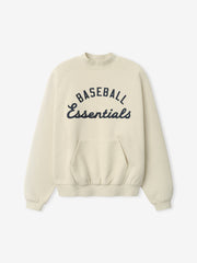 Cream-colored Mlb Sport Crewneck featuring navy blue "Baseball Essentials" text across the chest, ribbed cuffs and hem, and a front kangaroo pocket for casual comfort.