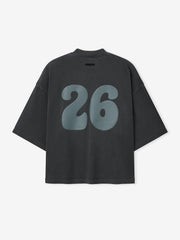 Heavy Jersey Merch Tee in a washed dark grey shade with an oversized fit and dropped shoulders, featuring large blue number 26 printed on the back for a vintage-inspired casual top.