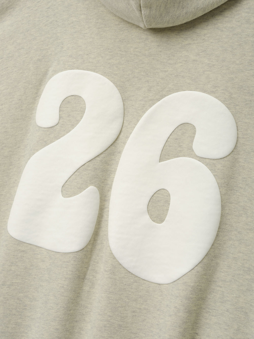 90'S Zip-Up Hoodie in a soft washed vanilla heather fabric featuring a close-up of large white padded numbers 26 printed on the back for a bold vintage-inspired look.