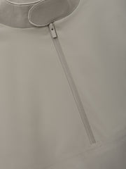 Half Zip Track Jacket in a muted neutral tone featuring a sleek front zipper and smooth fabric texture for a minimalist, modern outerwear option.
