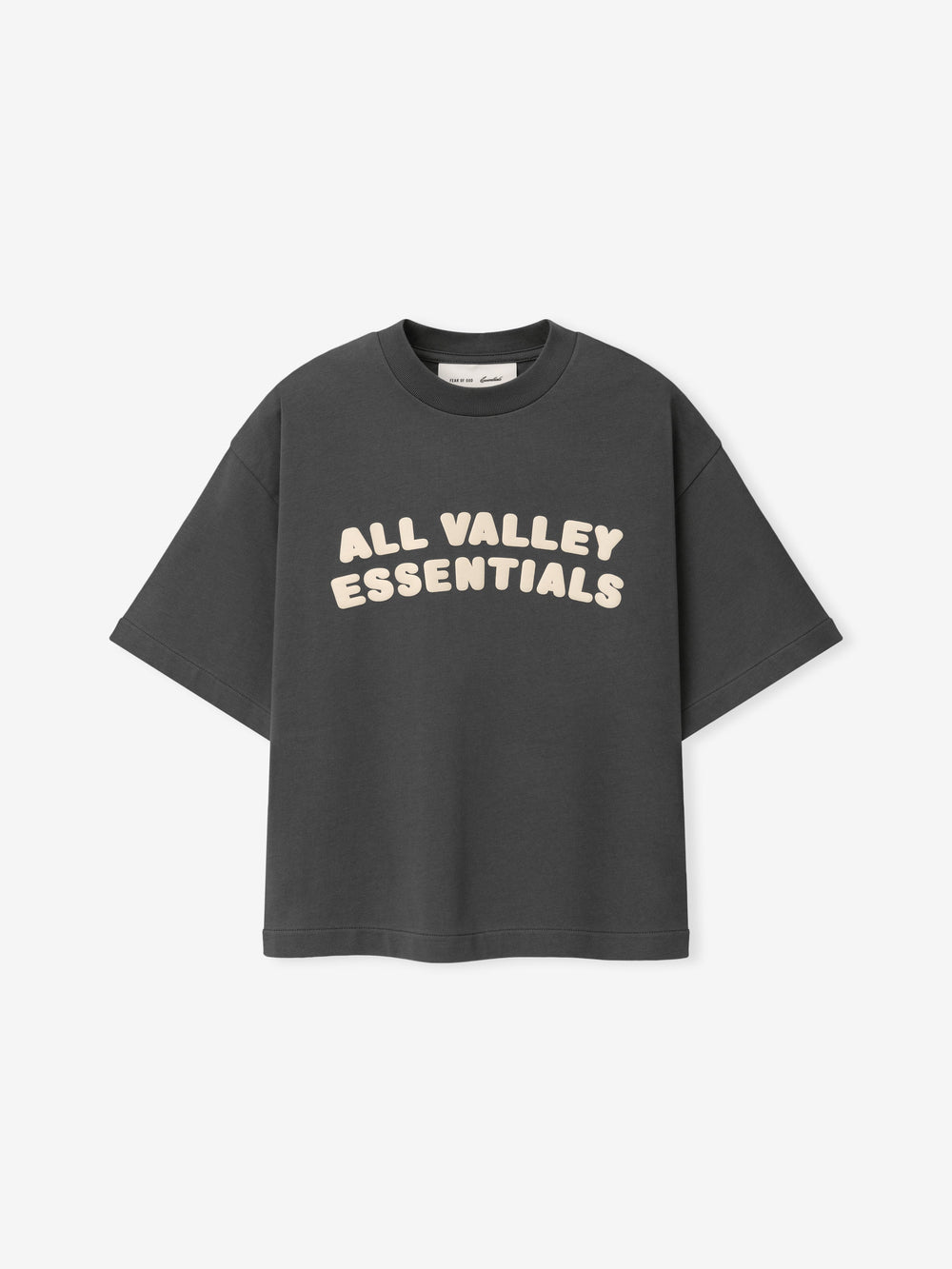 Kids Merch Tee in dark gray fabric featuring cream-colored bold text "ALL VALLEY ESSENTIALS" in playful rounded font across the chest for a casual kids top.