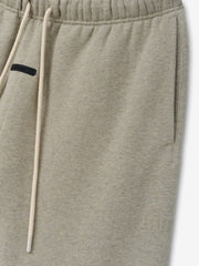 Classic Fleece Sweatpant in a muted beige heather shade featuring an elastic waistband with long drawstrings, side pockets, and a subtle tonal logo for comfortable casual bottoms.