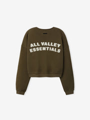 Womens French Terry Relaxed Half Zip in washed moss green, shown from the back with bold white printed lettering "All Valley Essentials" on soft, casual top.