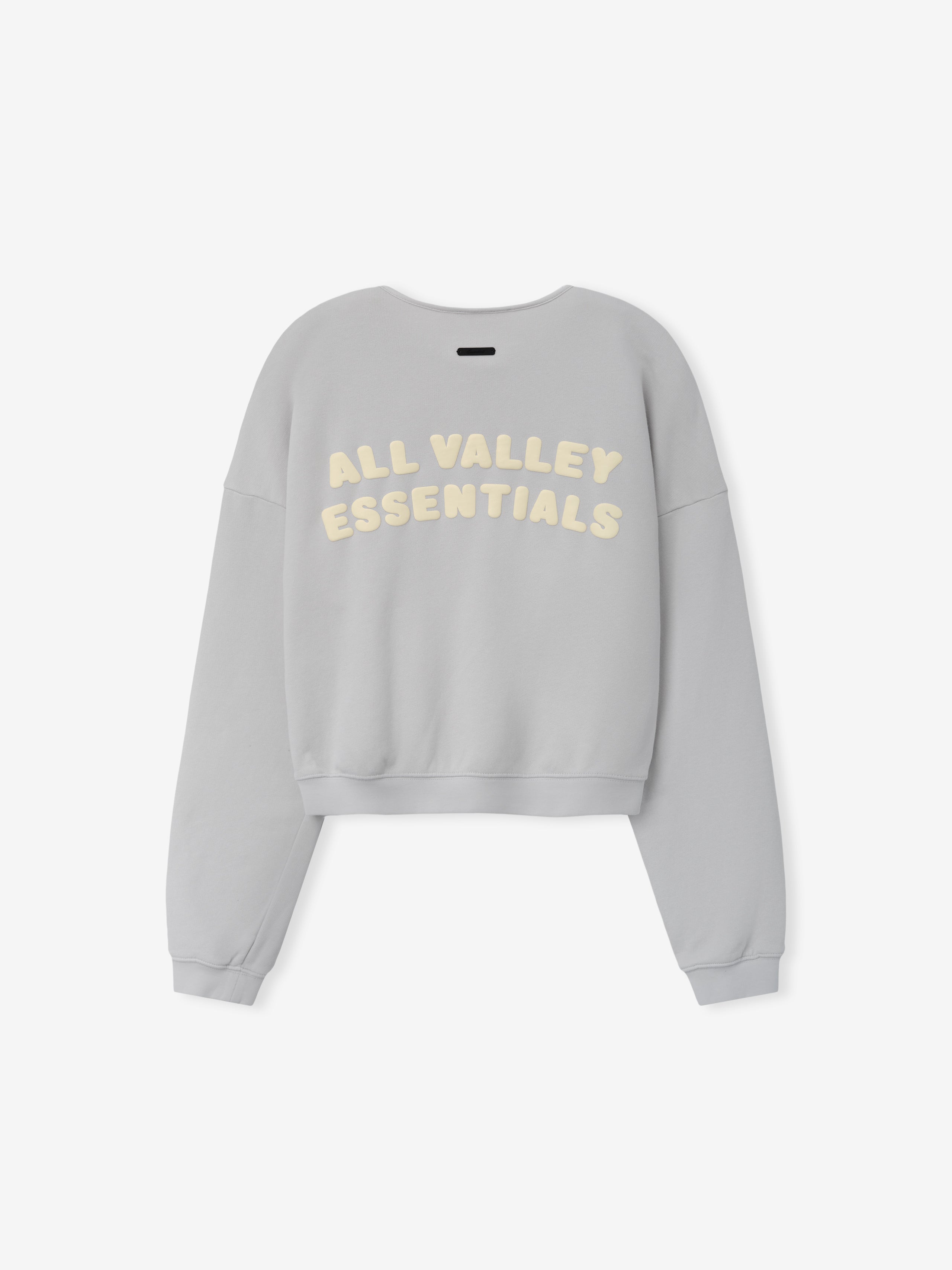 Womens French Terry Relaxed Half Zip in a soft washed grey shade, shown from the back with cream-colored "All Valley Essentials" lettering on a relaxed, comfortable casual top.