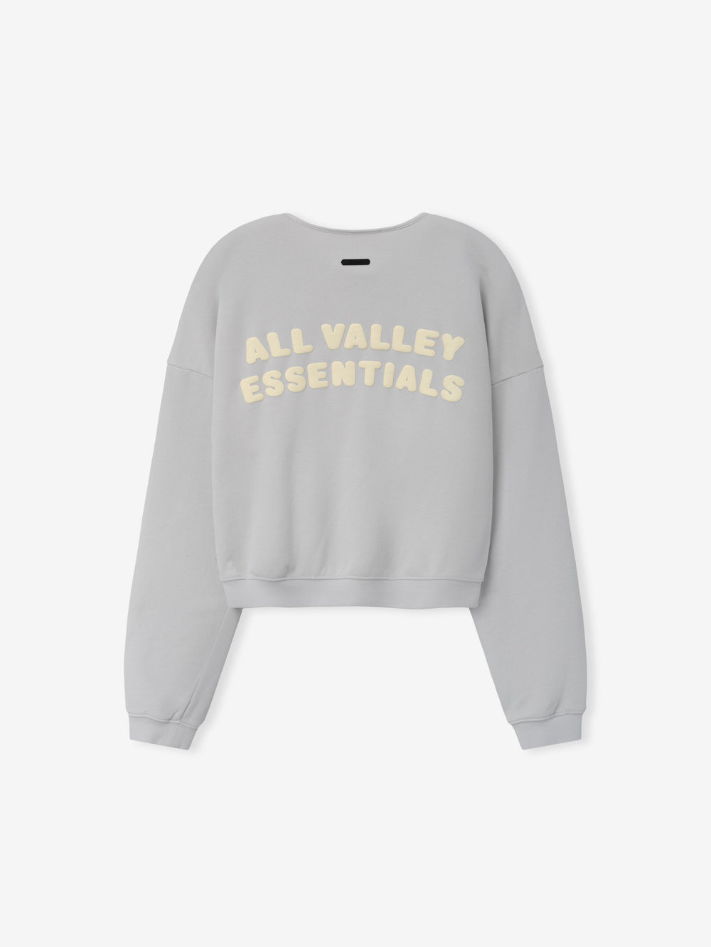 Womens French Terry Relaxed Half Zip in a soft washed grey shade, shown from the back with cream-colored "All Valley Essentials" lettering on a relaxed, comfortable casual top.