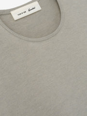 Womens Soft Knit Slim Longsleeve in a muted beige tone, crafted from fine knit fabric with a smooth round neckline and tailored slim fit for a versatile, sleek casual top.