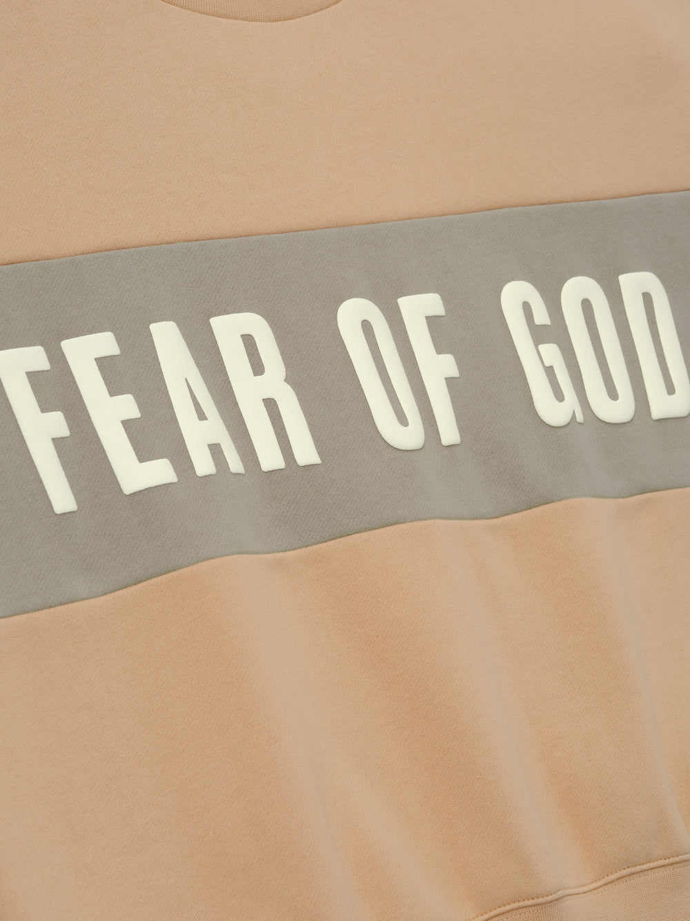 Womens Paneled Classic Sweatshirt in a warm beige shade with a contrasting muted gray panel across the chest featuring bold Fear of God lettering, designed as comfortable outerwear.
