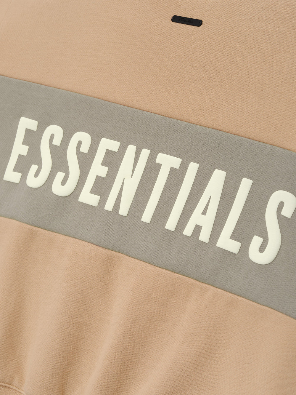 Womens Paneled Classic Sweatshirt in a warm ginger beige tone with a wide muted gray panel across the midsection, featuring bold white ESSENTIALS lettering on soft outerwear fabric.