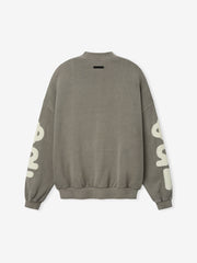 90'S Sweatshirt in a muted washed seal tone, showcasing a relaxed fit with dropped shoulders, ribbed cuffs and hem, and large contrasting lettering printed along the sleeves for casual tops.