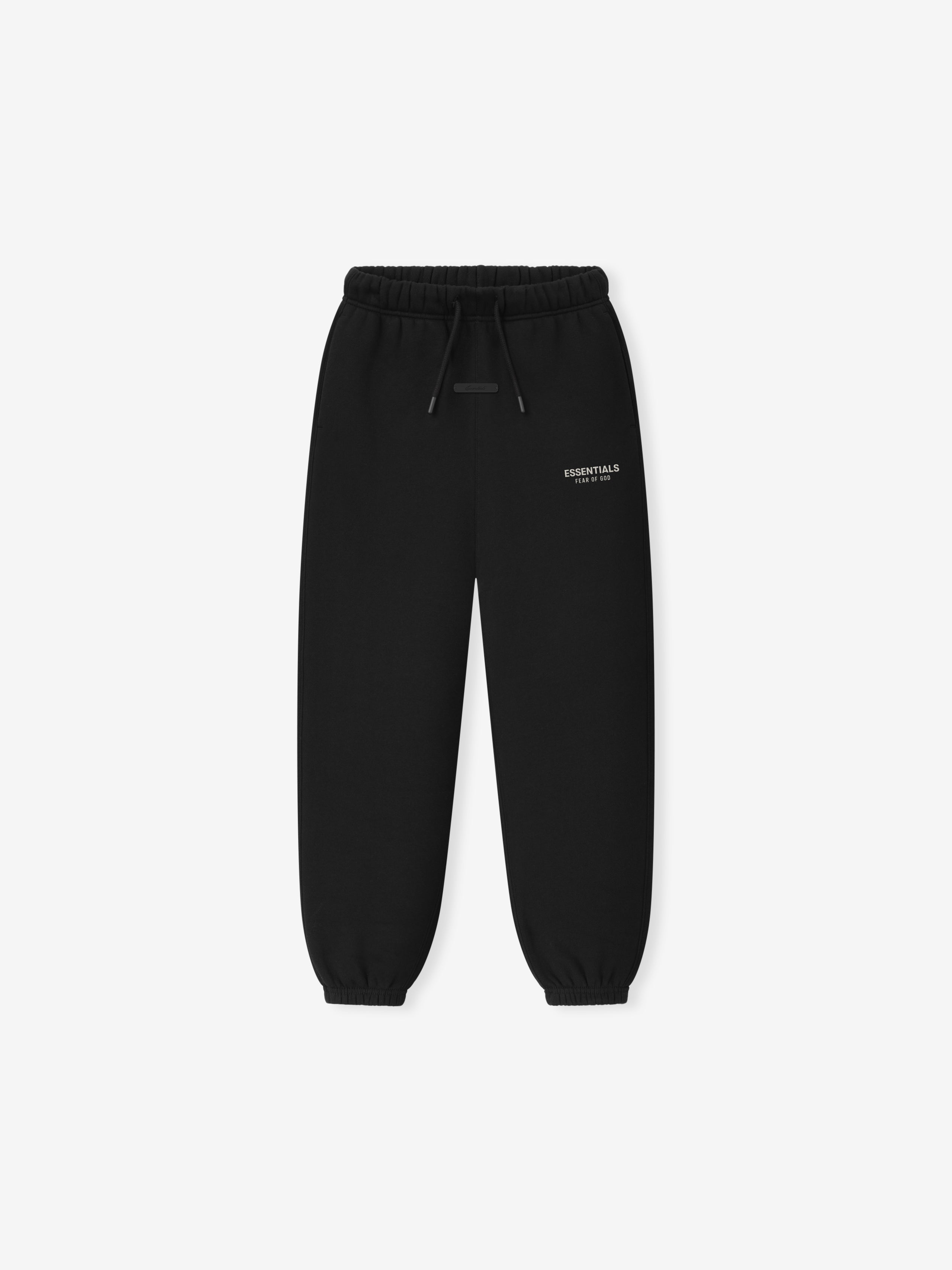 Kids Essentials FW26 Classic Sweatpant in black displayed flat with elastic drawstring waistband tapered legs ribbed cuffs and subtle Fear of God Essentials logo Bottoms