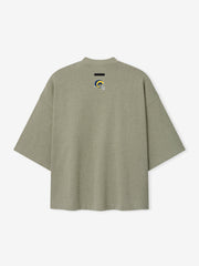 Rams Merch Tee olive gray oversized short sleeve shirt with a small blue and yellow Rams emblem and black chest label shown in a clean Tops product view
