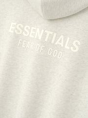 Womens Esssentials FW26 Classic Zip-Up Hoodie close up in light gray fleece showing raised white ESSENTIALS FEAR OF GOD chest branding Tops