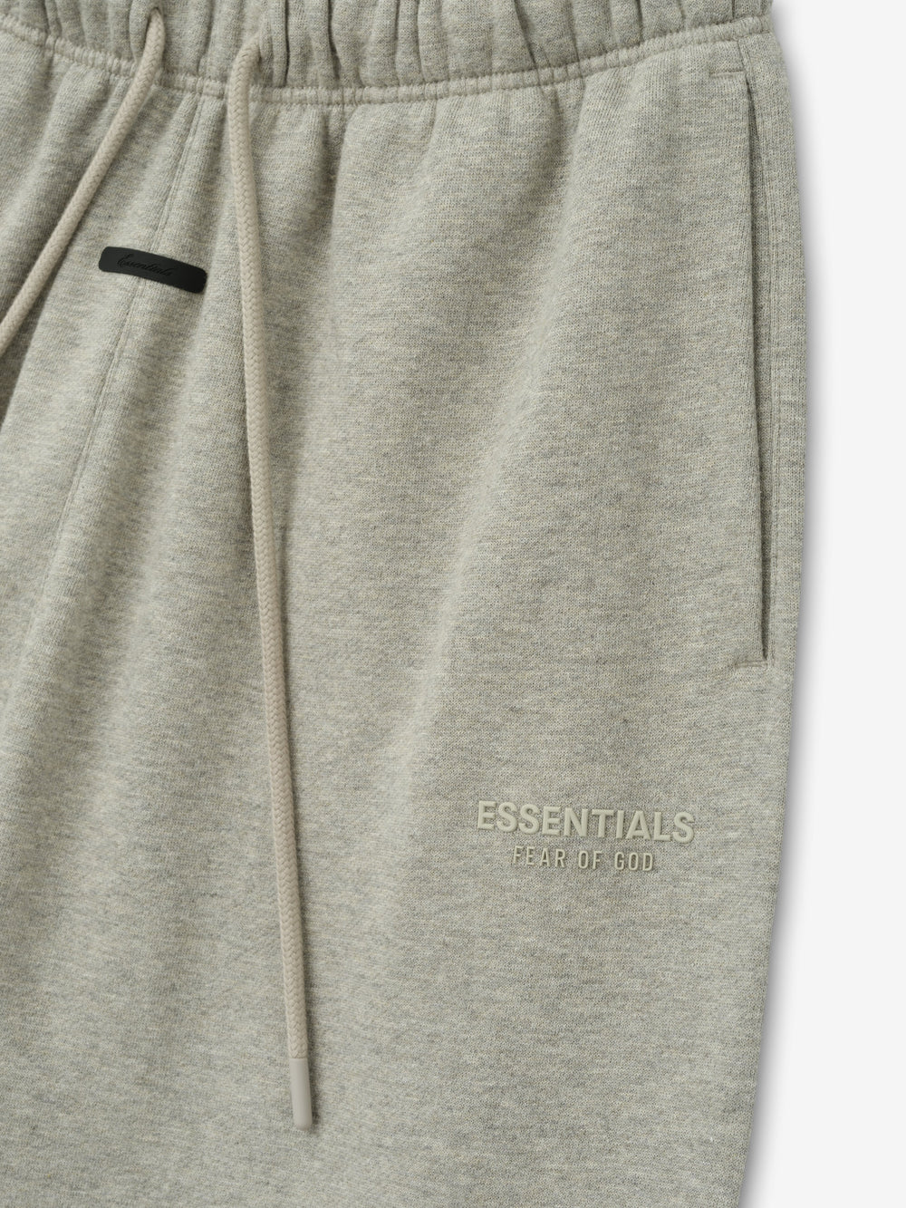Womens Essentals FW26 Classic Sweatpant close view in light gray fleece with drawstring waistband side pocket and subtle ESSENTIALS Fear of God logo Bottoms