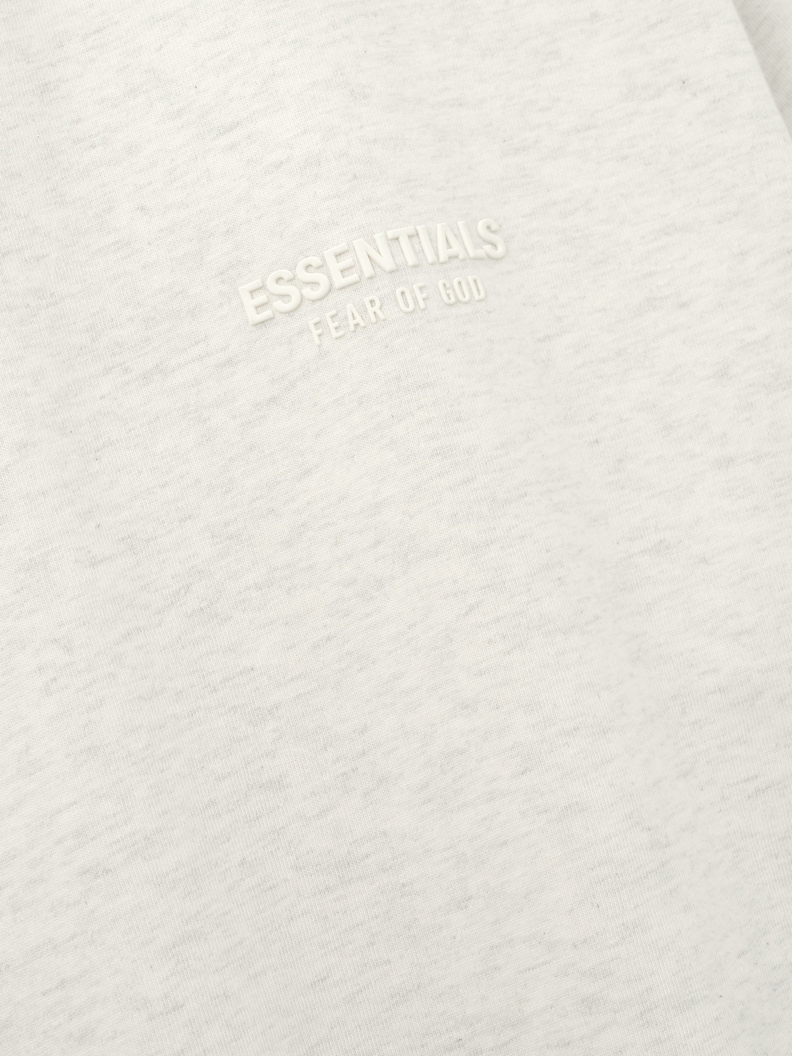 Essentials FW26 Classic Tee close up of soft off white cotton fabric with a raised tonal Essentials Fear of God chest logo Tops