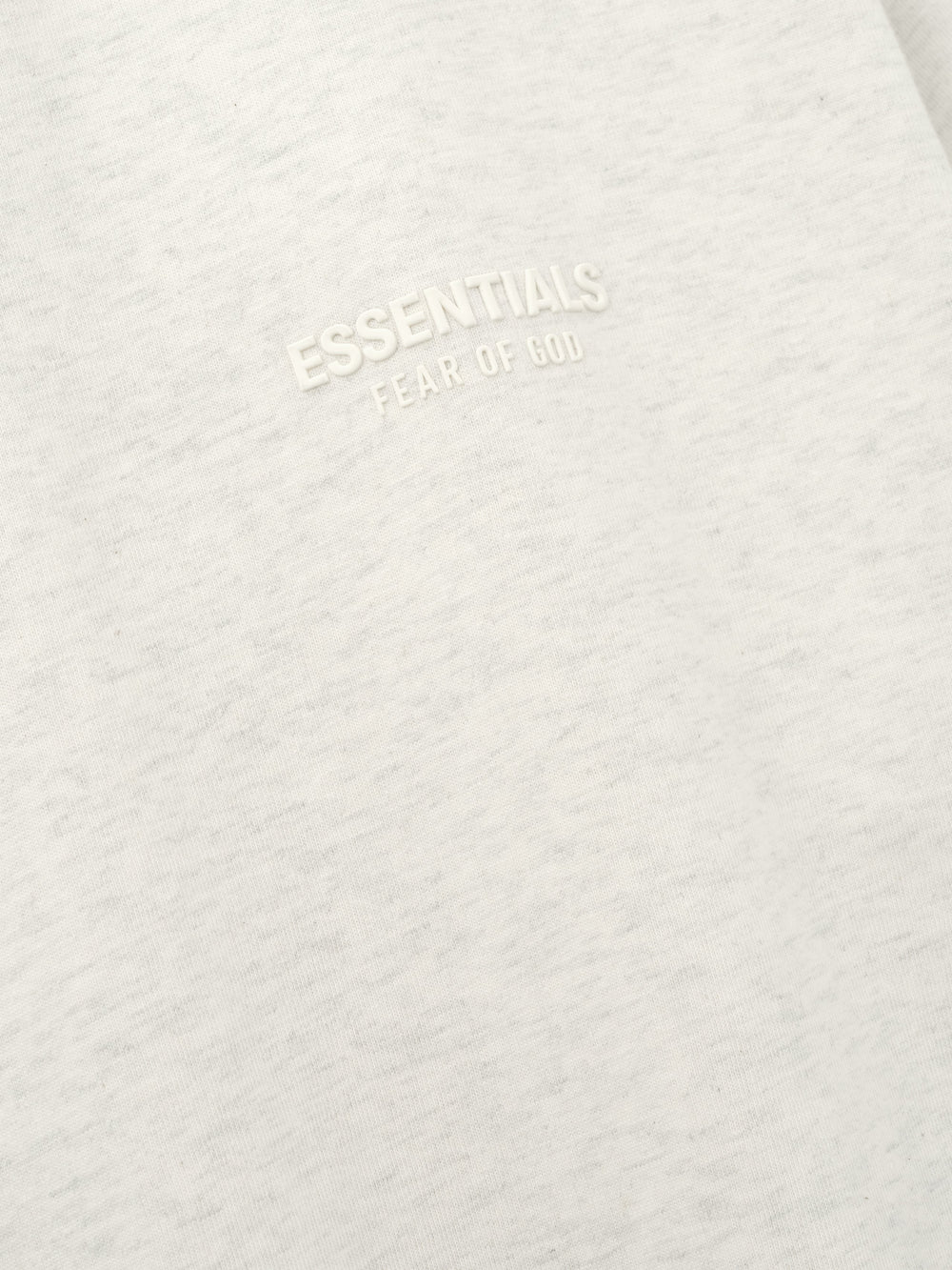 Essentials FW26 Classic Tee close up of soft off white cotton fabric with a raised tonal Essentials Fear of God chest logo Tops