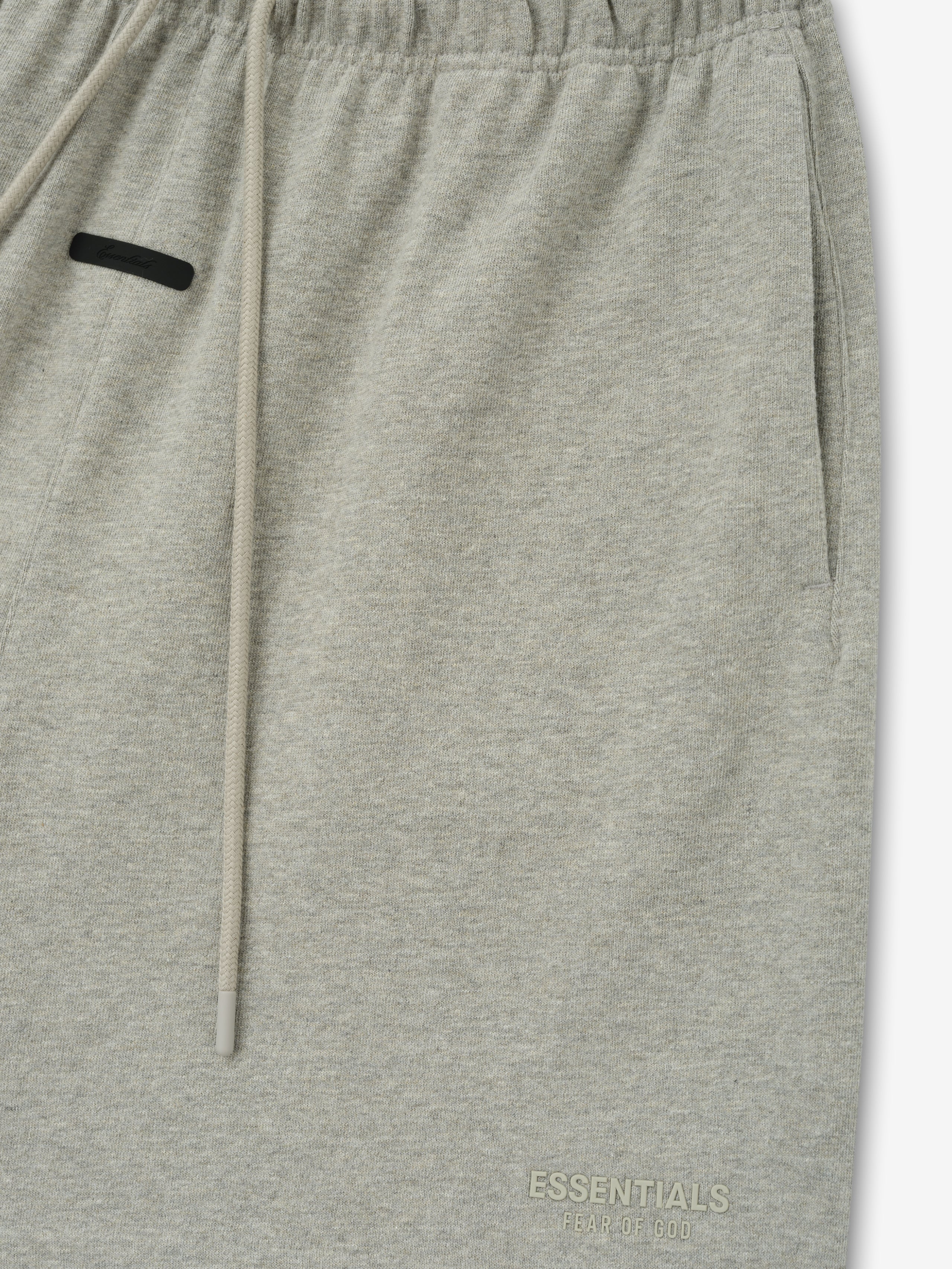 Essentials FW26 Classic Heavy Jersey Short in heather gray close up showing elastic waistband drawstring side pocket and subtle tonal logo detail Bottoms