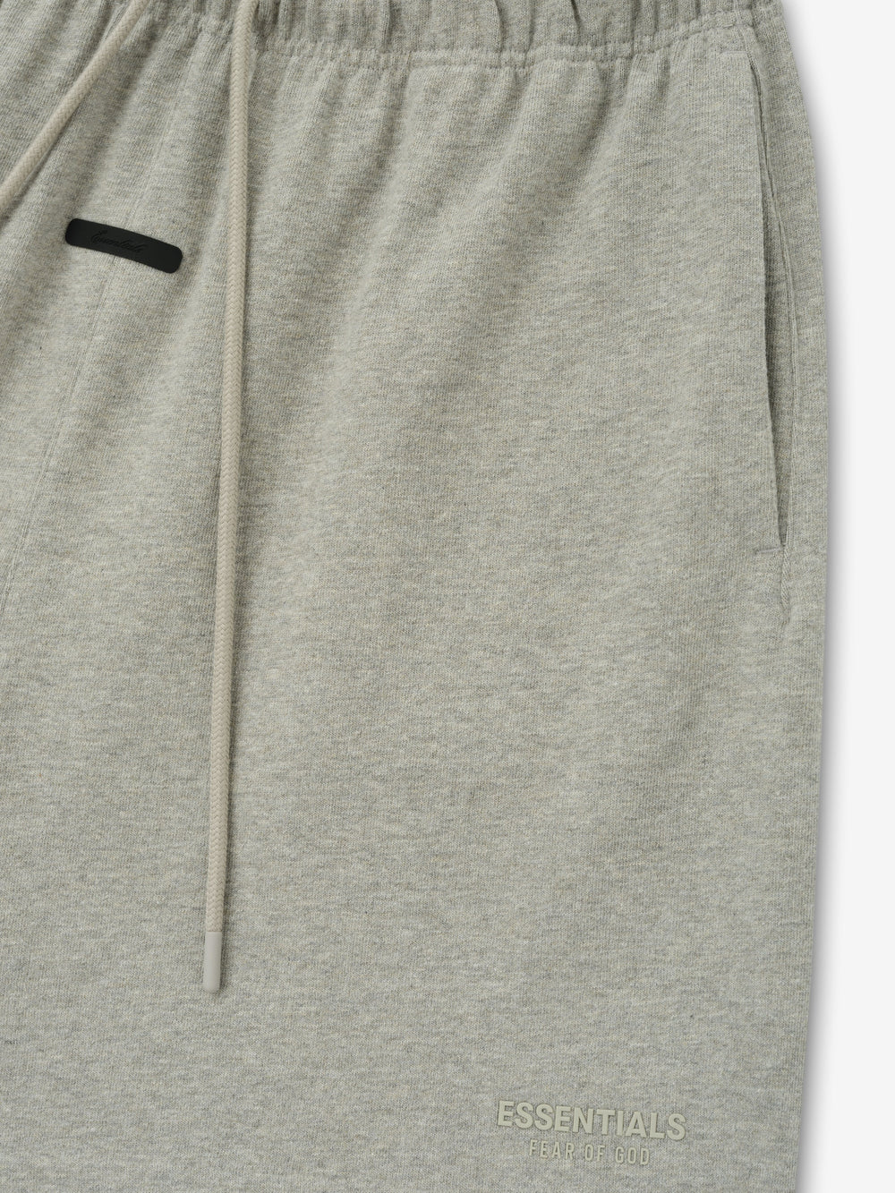 Essentials FW26 Classic Heavy Jersey Short in heather gray close up showing elastic waistband drawstring side pocket and subtle tonal logo detail Bottoms