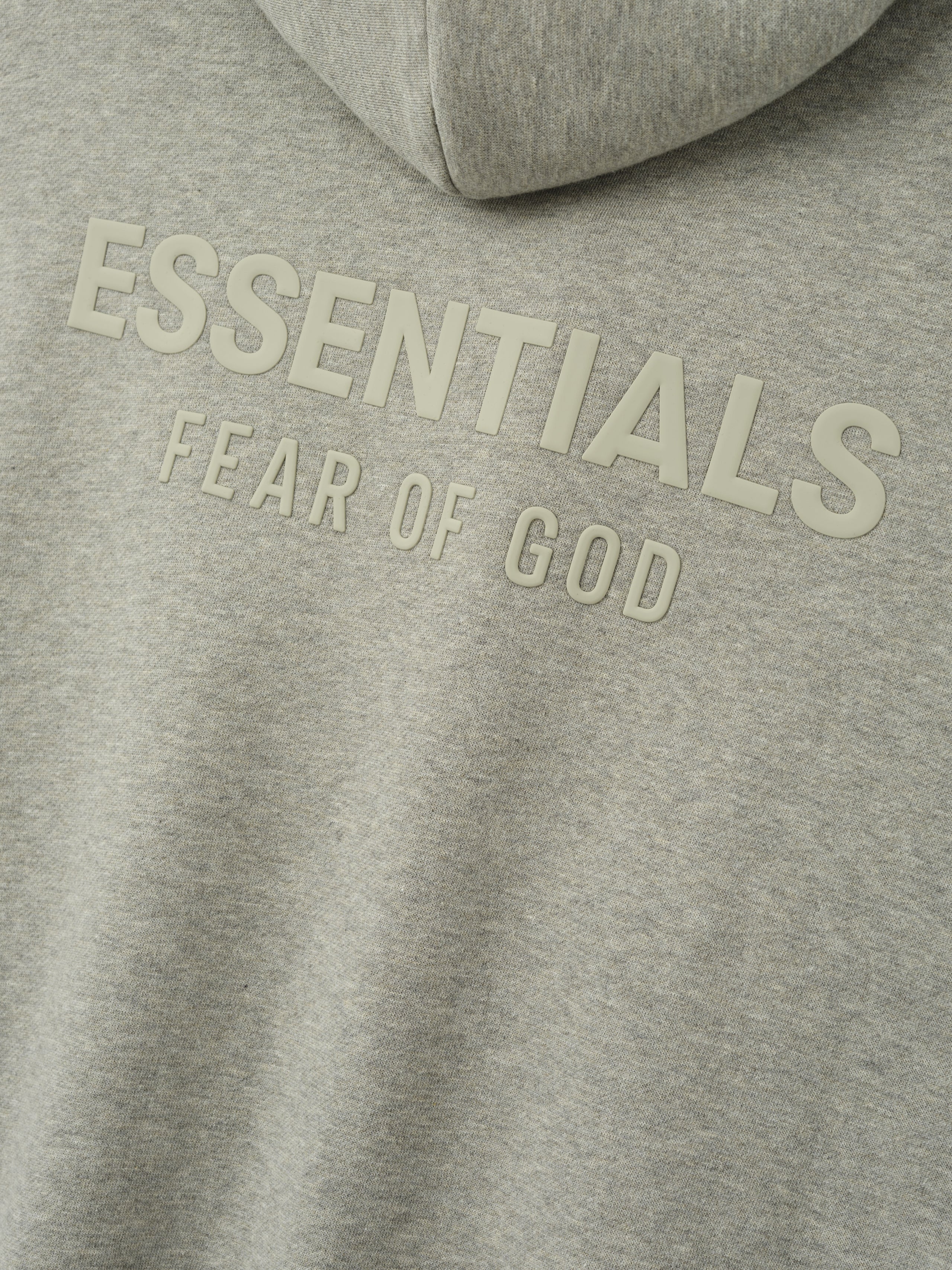 Essentials FW26 Classic Zip-Up Hoodie in heather gray close up with raised tonal Essentials Fear of God chest branding on soft fleece fabric Tops
