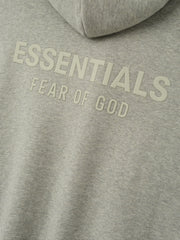 Essentials FW26 Classic Zip-Up Hoodie in heather gray close up with raised tonal Essentials Fear of God chest branding on soft fleece fabric Tops