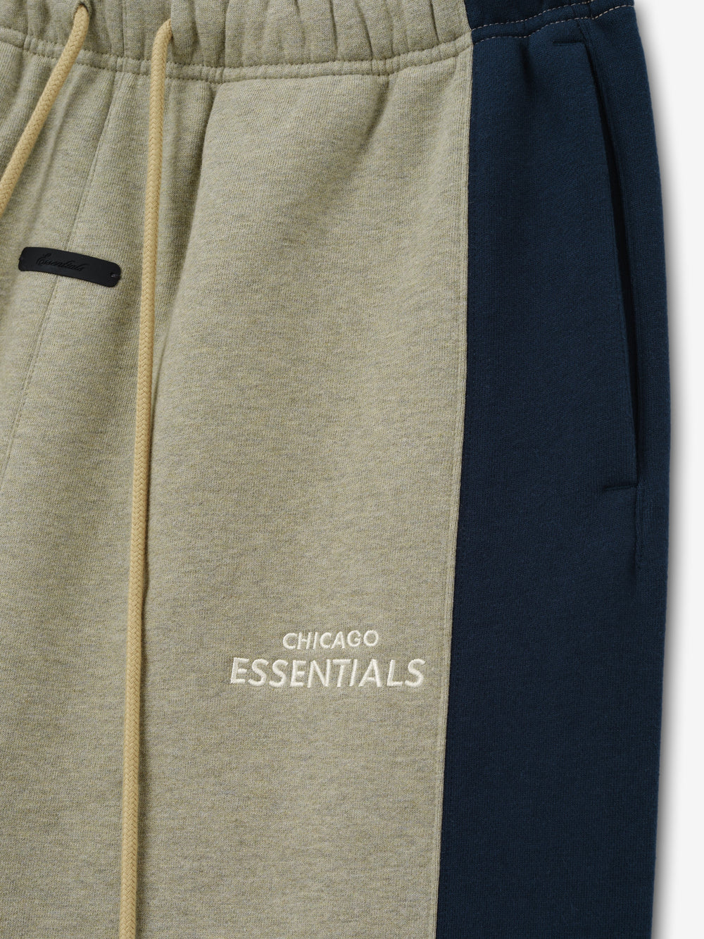 Bears Lounge Sweatpant close up in taupe fleece with navy side panel elastic drawstring waist black zip pocket and Chicago Essentials logo as a Bottoms product detail