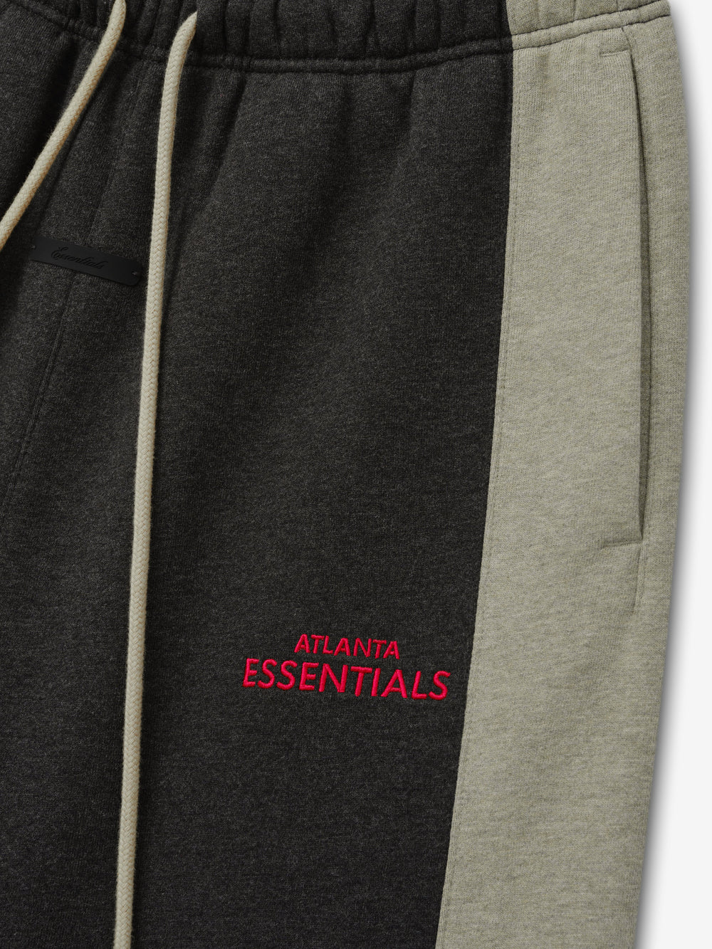 Falcons Lounge Sweatpant close up in black fleece with gray side panel cream drawstring and red Atlanta Essentials embroidery shown as a Bottoms product detail